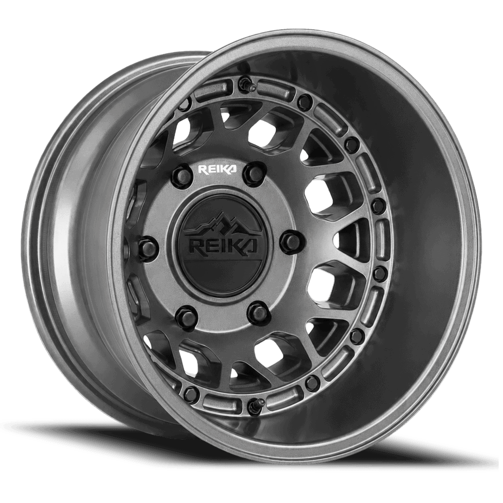 Alloy wheel rim with a dark center cap and REIKA logo, close-up view in metallic grey.